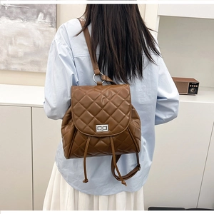 Brown quilted PU leather backpack with gold metal turn-lock and drawstring closure detail
