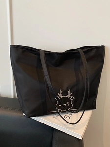 Minimalist black canvas tote bag with white deer embroidery for daily commute and school