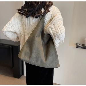 Detailed side view of large olive green faux suede tote bag showing its soft drape texture