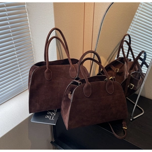Détail de sacs cabas en daim chocolat noir montrant la texture mate à la lumière