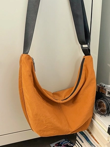 Lightweight orange half-moon crossbody bag made of durable nylon with adjustable strap