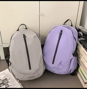 Detail of grey and purple backpacks featuring waterproof zippers and durable fabric