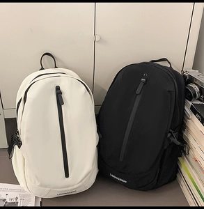 Detailed view of casual travel backpacks in black and white with vertical zipper design