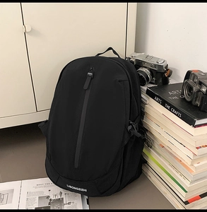 Close-up of black backpack featuring a vertical waterproof zipper and durable fabric