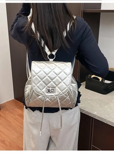 Quilted silver metallic backpack for women with chic diamond stitching and metal turn-lock