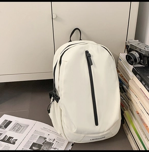 Detail of white nylon backpack featuring black vertical zipper and side adjustment buckle