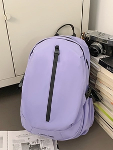 Light purple water-resistant nylon backpack for travel and school in a casual setting