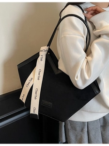 Matte black tote bag with white silk scarf detail and V-cut design for women