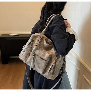 Dettaglio della borsa tote vintage con grande capacità e cerniere decorative a nappa