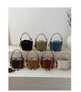 Detailed collection of woven bucket bags in seven colors with beaded charms and drawstring