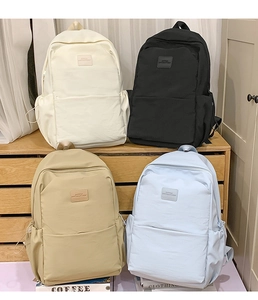 Detailed display of four durable nylon backpacks in cream, black, khaki, and light blue