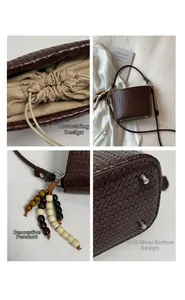 Detailed view of brown woven bucket bag with wood bead charm and metal protective feet