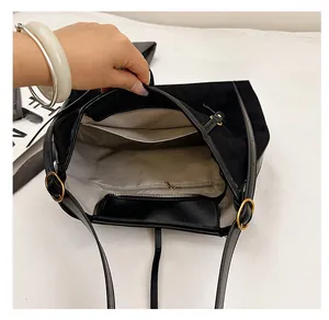Interior view of large suede tote bag featuring a zip pocket and metal hardware