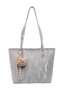 Grey large capacity tote bag with crinkle texture and cute bear pendant on white background
