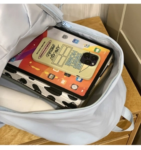 Detail view of large capacity light blue backpack with spacious storage for a tablet