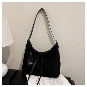 Close-up of black faux suede tote bag featuring sleek shoulder straps and ELONMAY brand tag