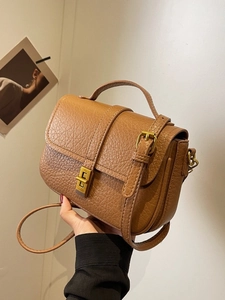 Retro dark brown pebbled leather crossbody bag with gold twist lock and top handle