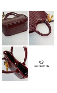 Detail view of woven burgundy tote bag texture with decorative wooden bead handle charms