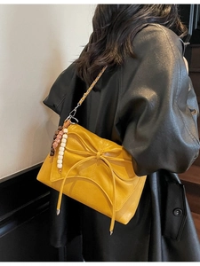 Fashionable bright yellow crossbody bag with bow decoration and beaded chain strap