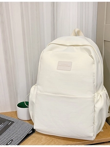 Cream white large capacity fashion backpack for students and business on wooden desk