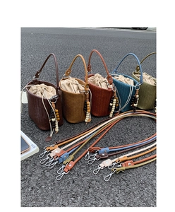 Five woven bucket bags in various colors with drawstring liners and wooden beads details