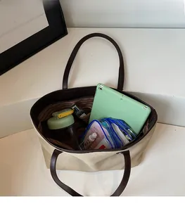 Top view of large canvas tote bag showing interior capacity with tablet and water bottle