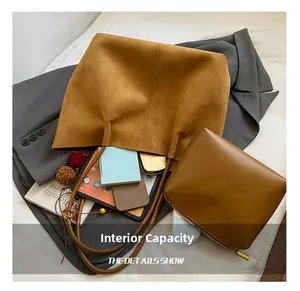 Interior view of large brown suede tote bag showing capacity for tablets and daily items