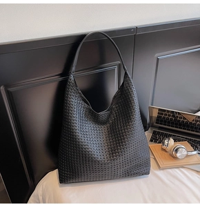 Close-up of the black woven texture and large capacity design of this modern tote bag