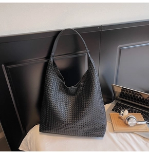 Macro detail of the premium black woven texture on this large stylish tote bag