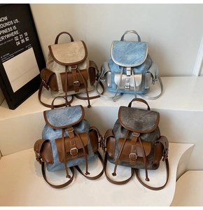 Collection of vintage high-capacity backpacks in beige, light blue, and grey with buckle detail