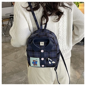 Detail of navy plaid mini backpack featuring a unique shirt collar and pink buttons