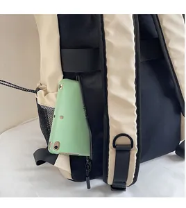 Detail of the nylon backpack showing a functional side mesh pocket and zipper compartment