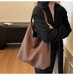 Detailed close-up showing the premium Intrecciato woven texture of the large hobo tote bag