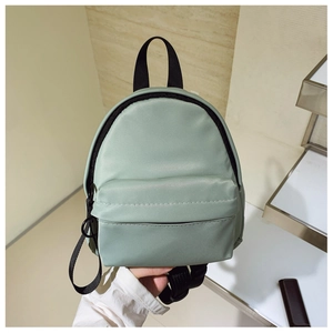 Handheld mint green mini nylon backpack with front zipper pocket and adjustable black straps