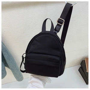Vertical view of black mini nylon backpack with adjustable straps and silver hardware detail