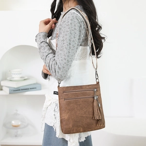 Brown vintage crossbody bag with fringe, multi-zipper pockets and ethnic strap