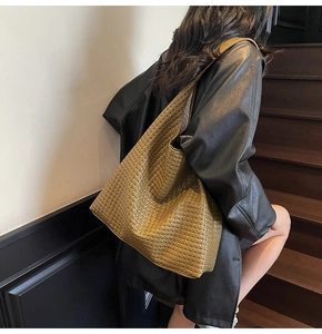 Detailed view of woven leather texture on a large olive green Hobo tote shoulder bag