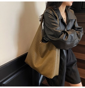 Detail of woven leather texture on a large olive brown hobo shoulder tote bag