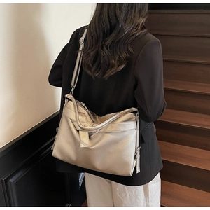 Silver metallic hobo bag detail showing the adjustable strap and pebbled leather texture