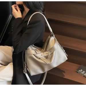 Close-up of metallic silver tote bag featuring lychee texture and buckle strap detail