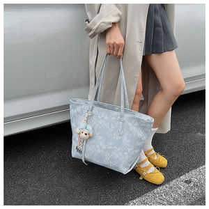 Hellblaue Shopper-Tasche mit Blumenmuster und süßem Anhänger im Streetstyle-Look