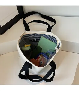 Top view of large white canvas tote bag showing spacious interior with striped lining