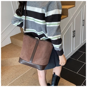 Brown frosted suede bucket bag shown on a model highlighting size and crossbody strap