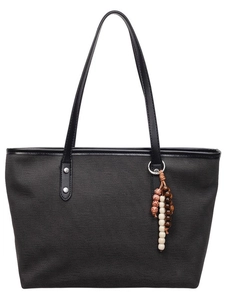 Large black canvas tote bag with leather straps and ethnic beaded charm on white background