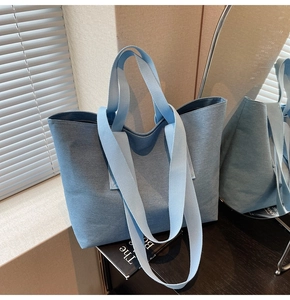 Detail of lake blue canvas tote bag showing thick textured fabric and wide carry handles