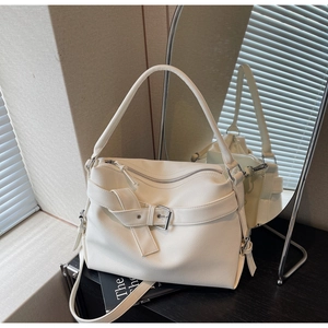 Macro shot of white lychee texture tote bag with buckle strap and mirror reflection detail