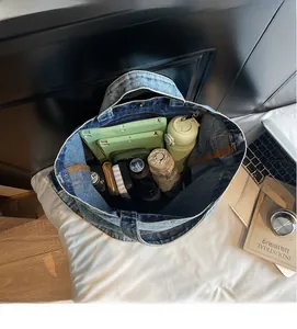 Spacious denim tote bag showing interior storage for iPad, umbrella, and essentials
