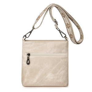 Detail of beige canvas crossbody bag with ethnic patterned wide adjustable strap