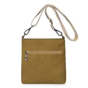 Detail of canvas crossbody bag featuring multi-zipper pockets and patterned wide strap