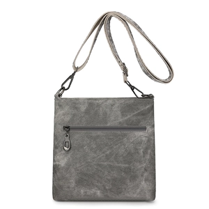 Detail showing vintage gray wash texture and gunmetal hardware on the square crossbody bag